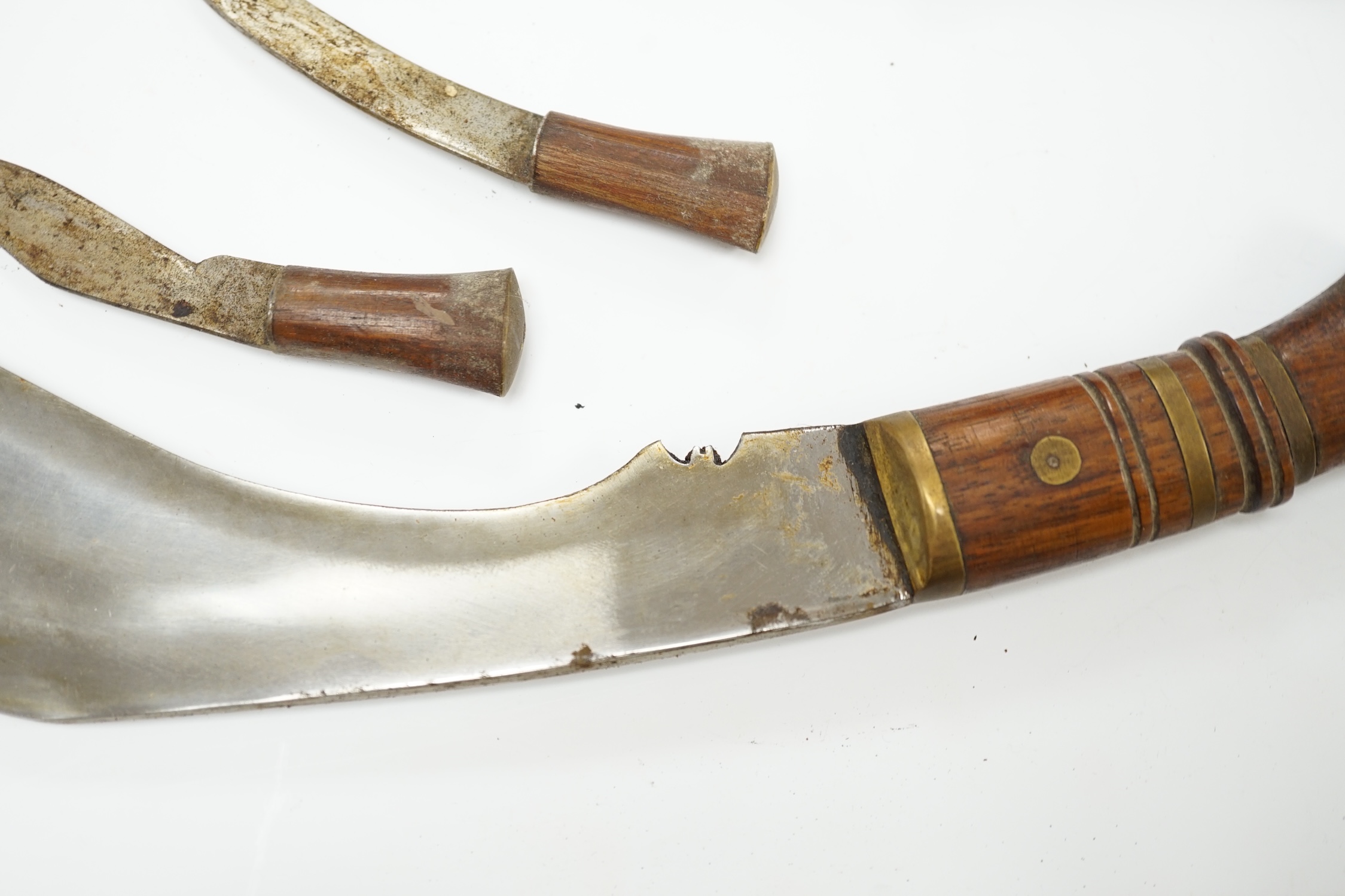 An Indian Kukri with brass mounted wooden handle its leather sheath, and a Moroccan Jambiya. Condition - good